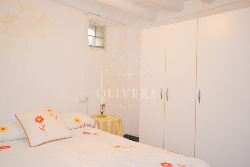 Habitación 2 con cama de matrimonio, mesitas, espejo y armario de tres puertas.