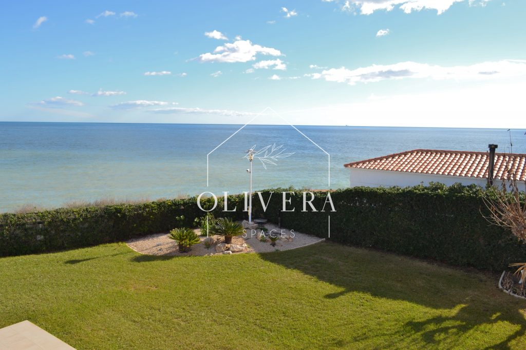 exterior de la casa con jardín de césped natural y vistas al mar