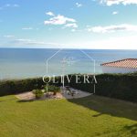 exterior de la casa con jardín de césped natural y vistas al mar